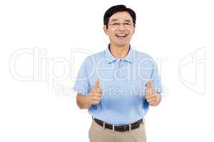 Portrait of cheerful man showing thumbs up while standing