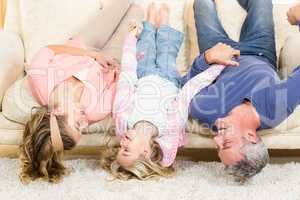 Parents and child upside down on the couch
