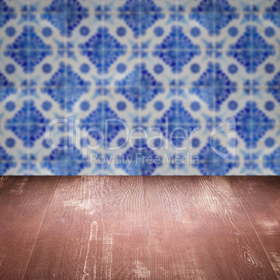 Wood table top and blur vintage ceramic tile pattern wall