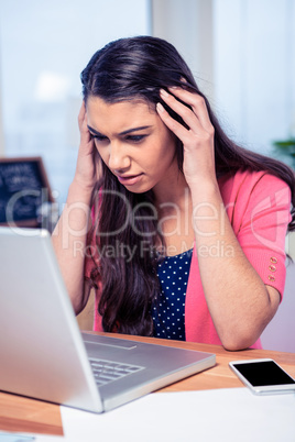 Businesswoman with laptop in creative office