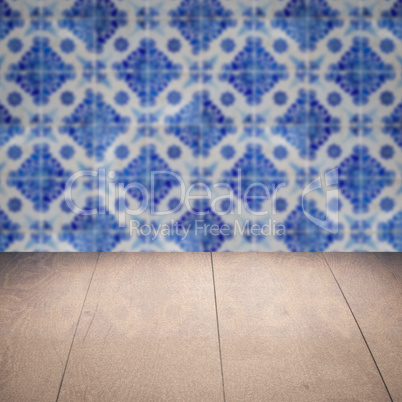 Wood table top and blur vintage ceramic tile pattern wall
