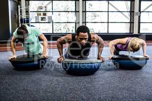 Fit people doing bosu push ups