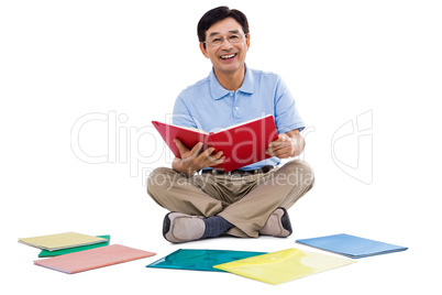 Smiling man reading books