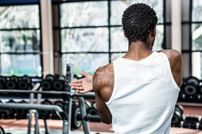 Rear view of man stretching arms