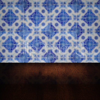 Wood table top and blur vintage ceramic tile pattern wall