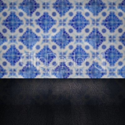 Wood table top and blur vintage ceramic tile pattern wall