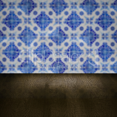 Wood table top and blur vintage ceramic tile pattern wall