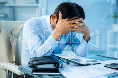 Worried businessman working at his desk