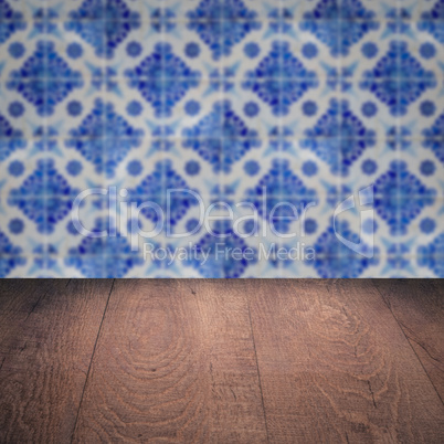 Wood table top and blur vintage ceramic tile pattern wall