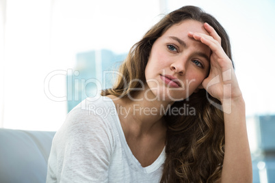 Woman thinking on sofa