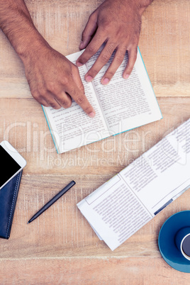 Man reading book on table