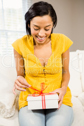 Happy brunette opening gift