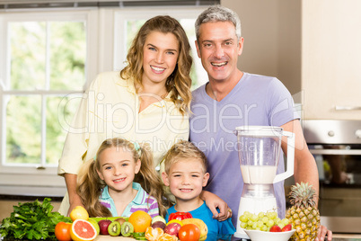 Happy family preparing healthy smoothie