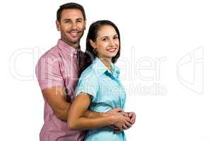 Attractive couple hugging and smiling at camera