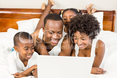 Happy family lying on the bed