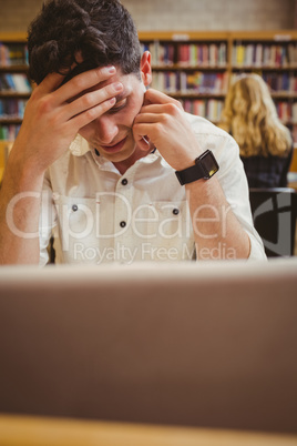 Focused student using his laptop while working