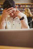 Focused student using his laptop while working