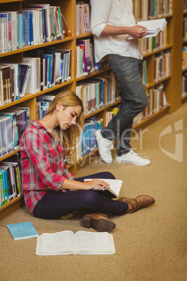 Female student working on floor