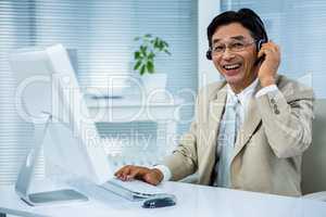 Smiling businessman using headset