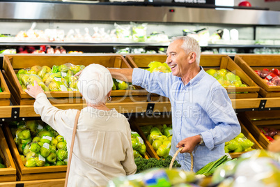 Senior couple picking out fruits together