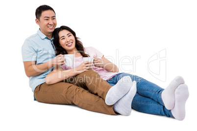 Full length happy young couple with cup