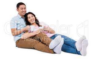 Full length happy young couple with cup