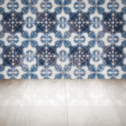 Wood table top and blur vintage ceramic tile pattern wall