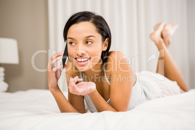 Smiling brunette on a phone call