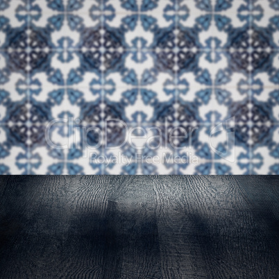 Wood table top and blur vintage ceramic tile pattern wall Wood table top and blur vintage ceramic tile pattern wall