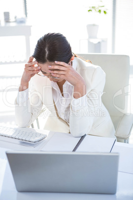 Stressed businesswoman working at her desk