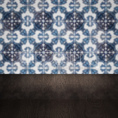 Wood table top and blur vintage ceramic tile pattern wall