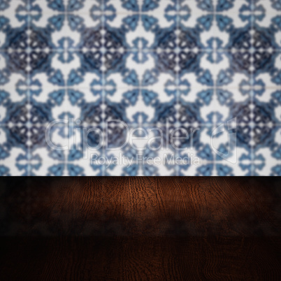 Wood table top and blur vintage ceramic tile pattern wall