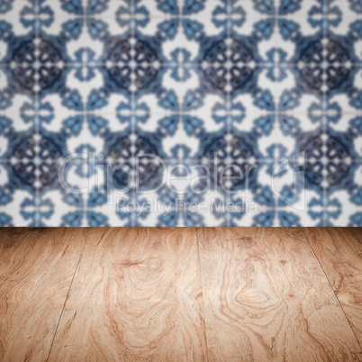 Wood table top and blur vintage ceramic tile pattern wall