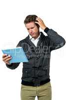 Confused man with digital tablet