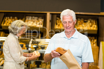 Senior couple buying bread