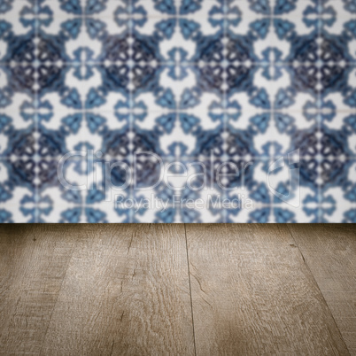 Wood table top and blur vintage ceramic tile pattern wall