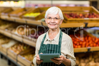 Senior employee working with tablet