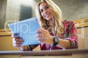 Smiling female student using tablet