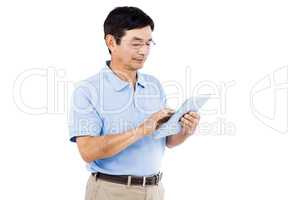 Confident man using digital tablet while standing