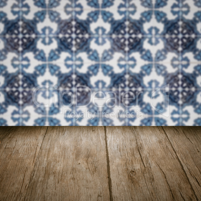 Wood table top and blur vintage ceramic tile pattern wall