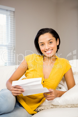Smiling brunette reading document