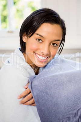 Attractive brunette on the sofa under blanket