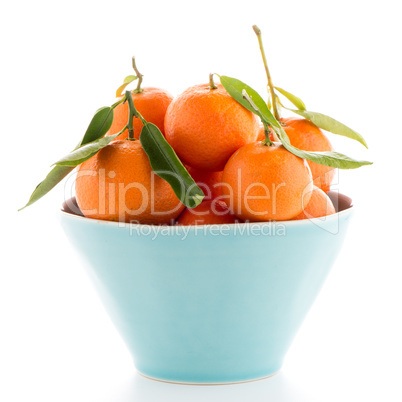 Tangerines on ceramic blue bowl