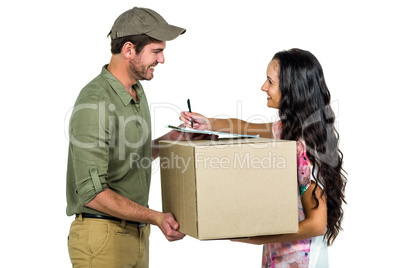 Woman signing for pack delivery with smiling postman
