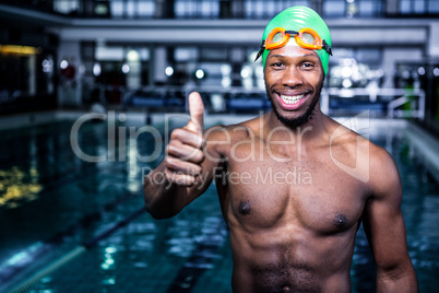 Fit swimmer standing with thumbs up