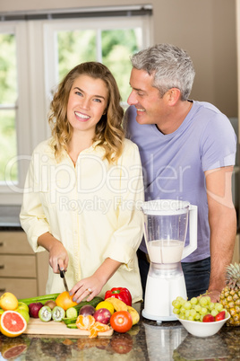 Smiling couple preparing healthy smoothie