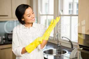 Smiling brunette wearing yellow gloves