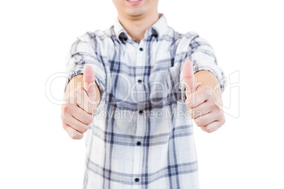 Midsection of man showing thumbs up