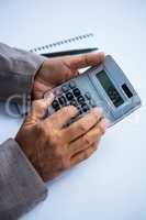 Businessman holding and using calculator