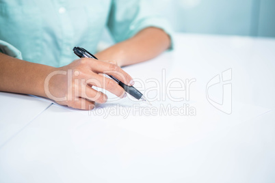 Close up view of a businesswoman writing notes